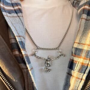 Unisex silver skeleton necklace featuring a bold, grunge-inspired design